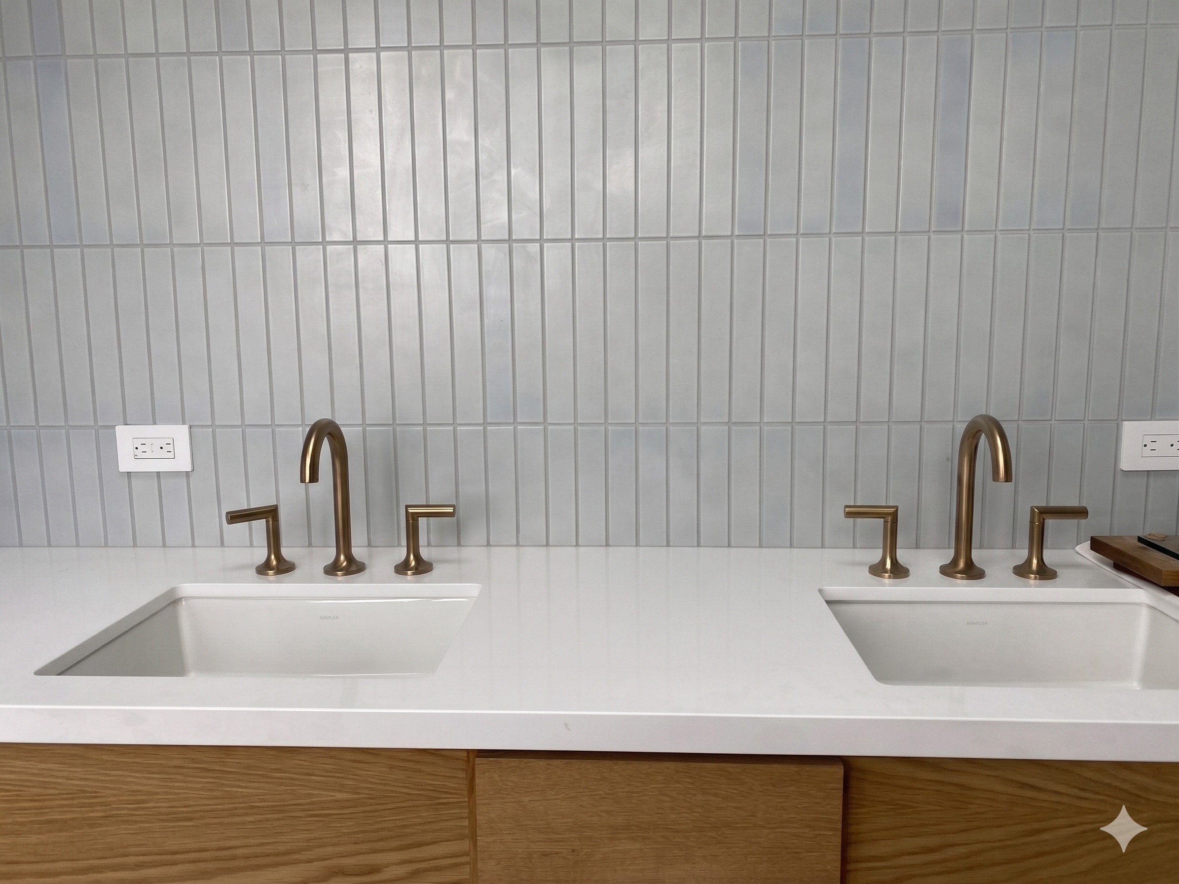 Custom double vanity install with brass faucets and quartz countertop, completed by TrueFlow MD
